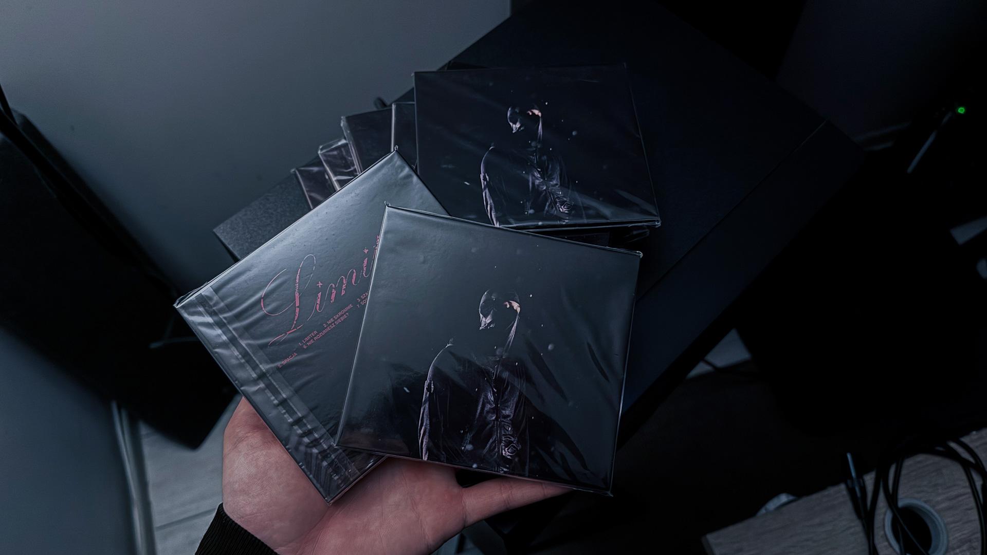 Photograph of the final physical product, showing the printed Limiter EP CDs housed inside their custom-designed graphic packaging